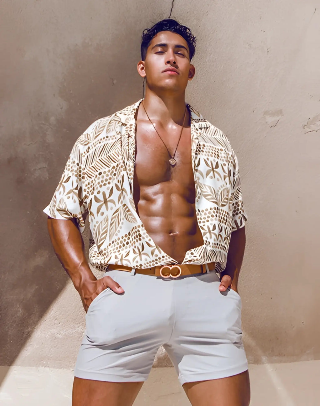 A tan and white patterned short-sleeved shirt with leaf and dot motifs paired with 2EROS bondi shorts string brown