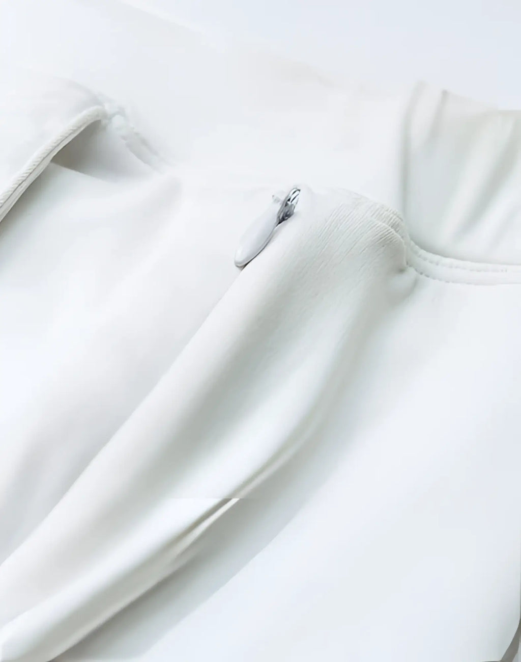 A sleek minimalist white zipper pull with a smooth metallic finish on 2EROS Bondi Shorts Series 3 white