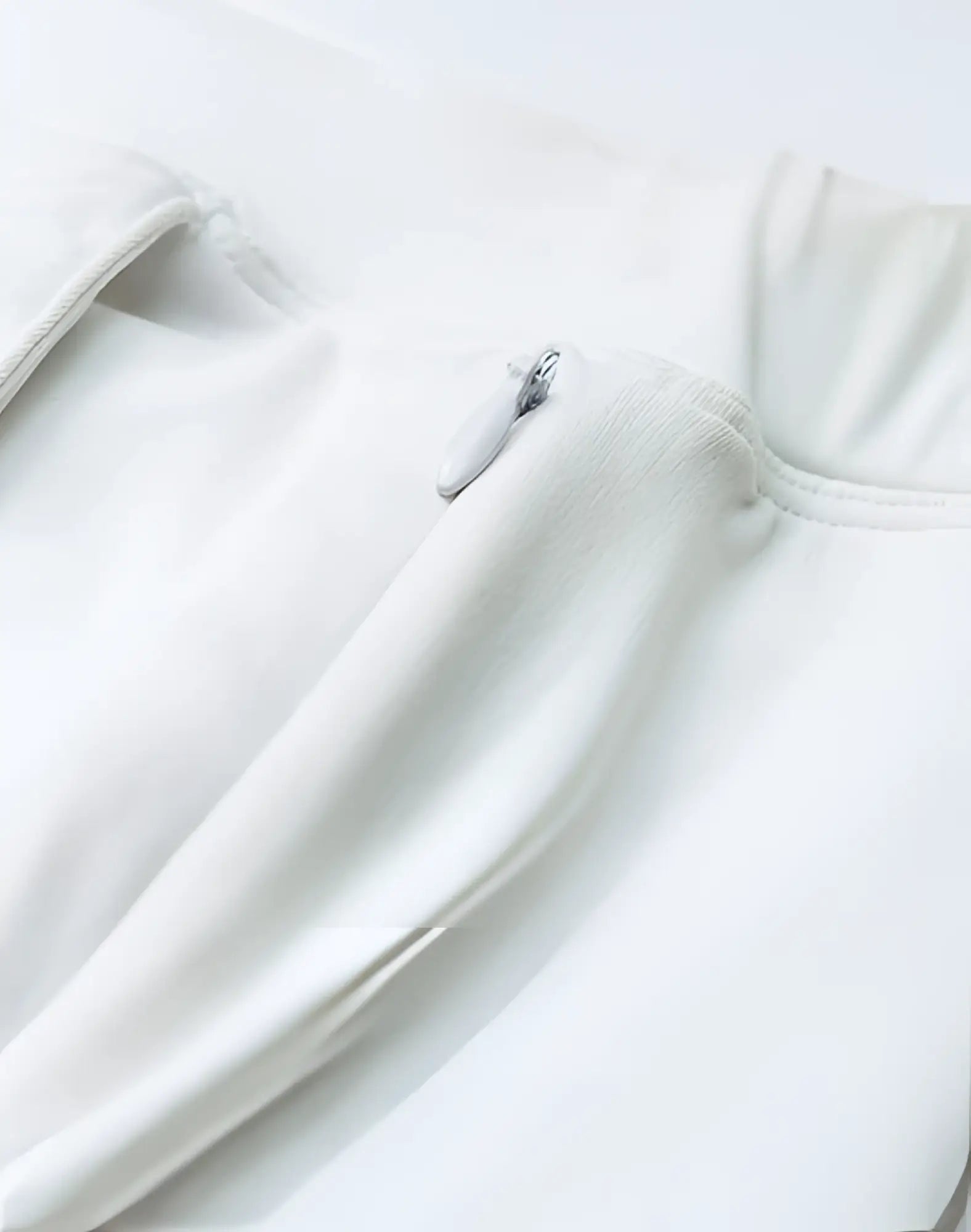 A sleek minimalist white zipper pull with a smooth metallic finish on 2EROS Bondi Shorts Series 3 white