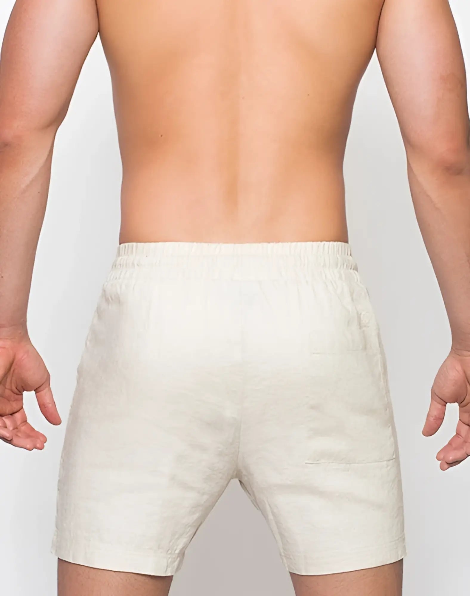 Back view of 2EROS breezy beige linen shorts with elastic waistband and two back pockets