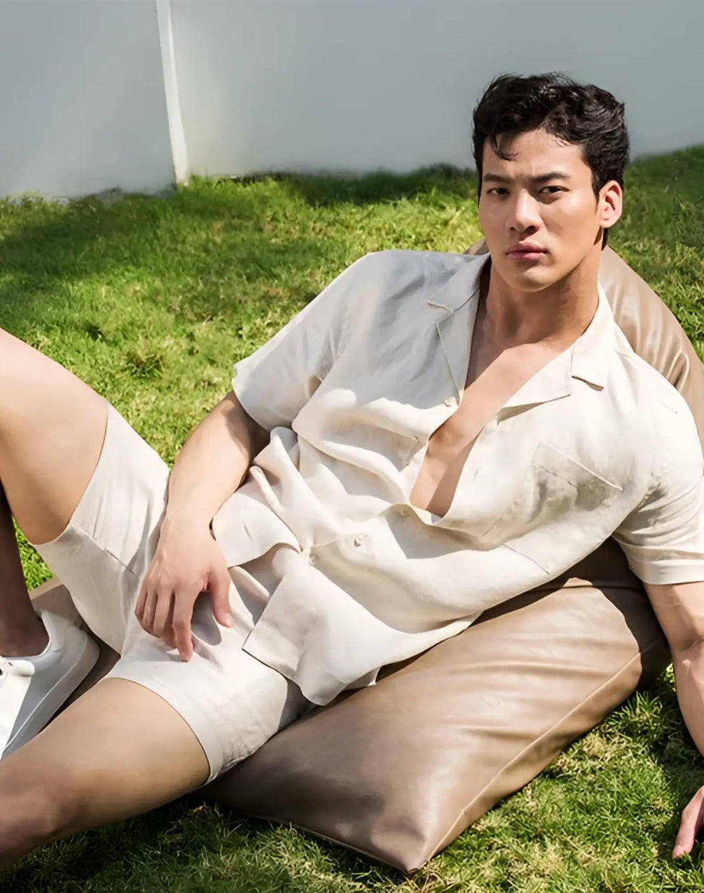 A man wearing a beige 2EROS breezy linen short sleeve classic shirt and matching shorts with a relaxed fit