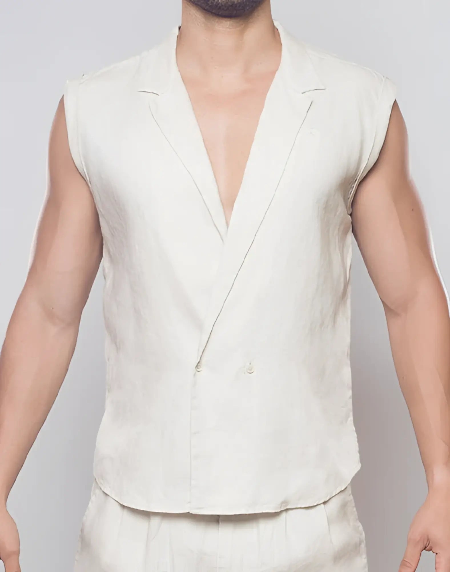 A sleek off-white linen sleeveless blazer with a classic notched collar and double-breasted front by 2EROS