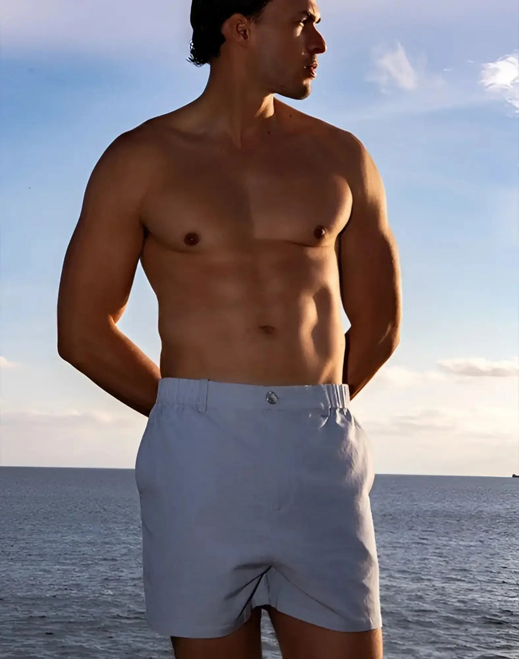 Light blue 2EROS capri cotton shorts with subtle woven texture and small metallic button at the waistband