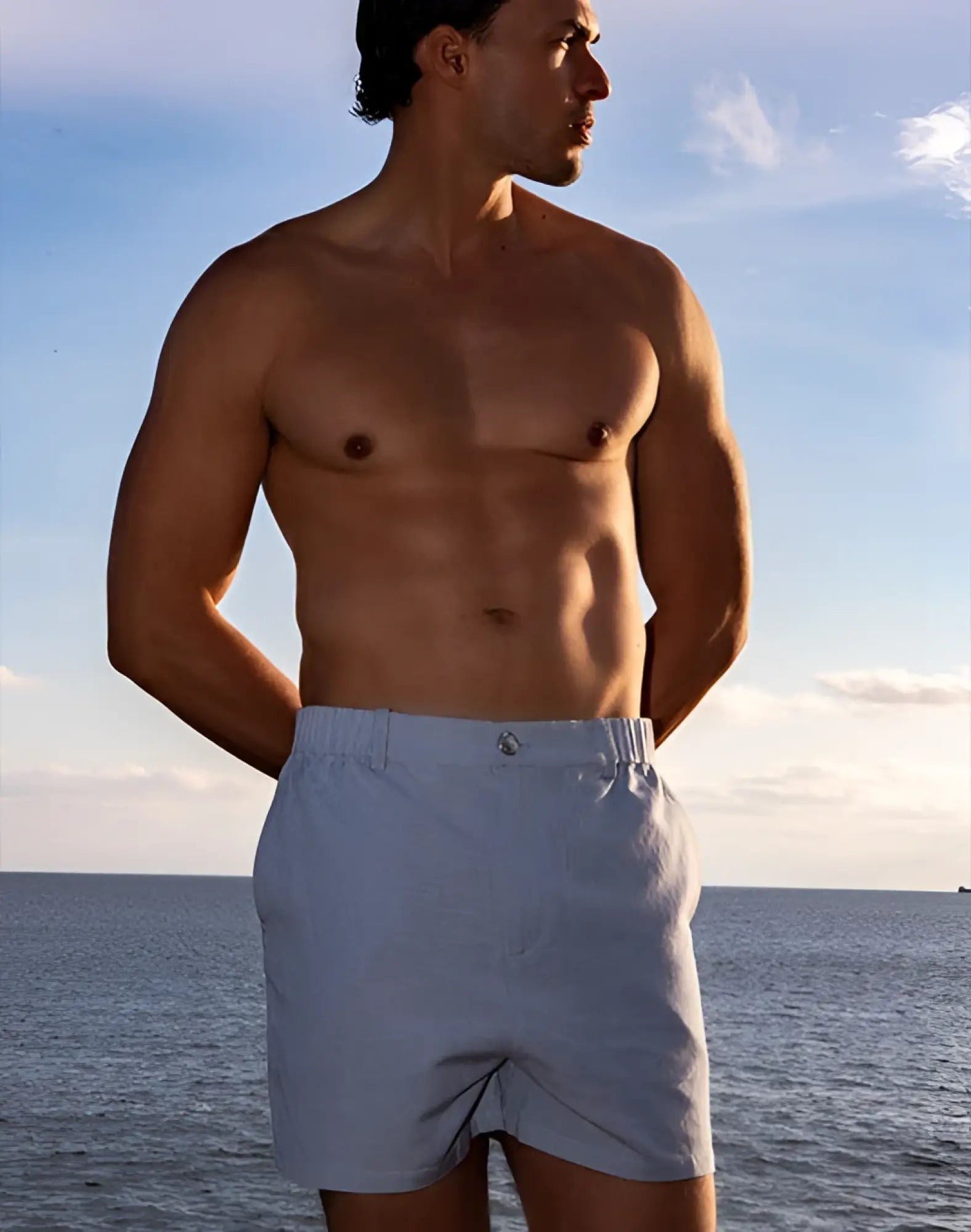 Light blue 2EROS capri cotton shorts with subtle woven texture and small metallic button at the waistband