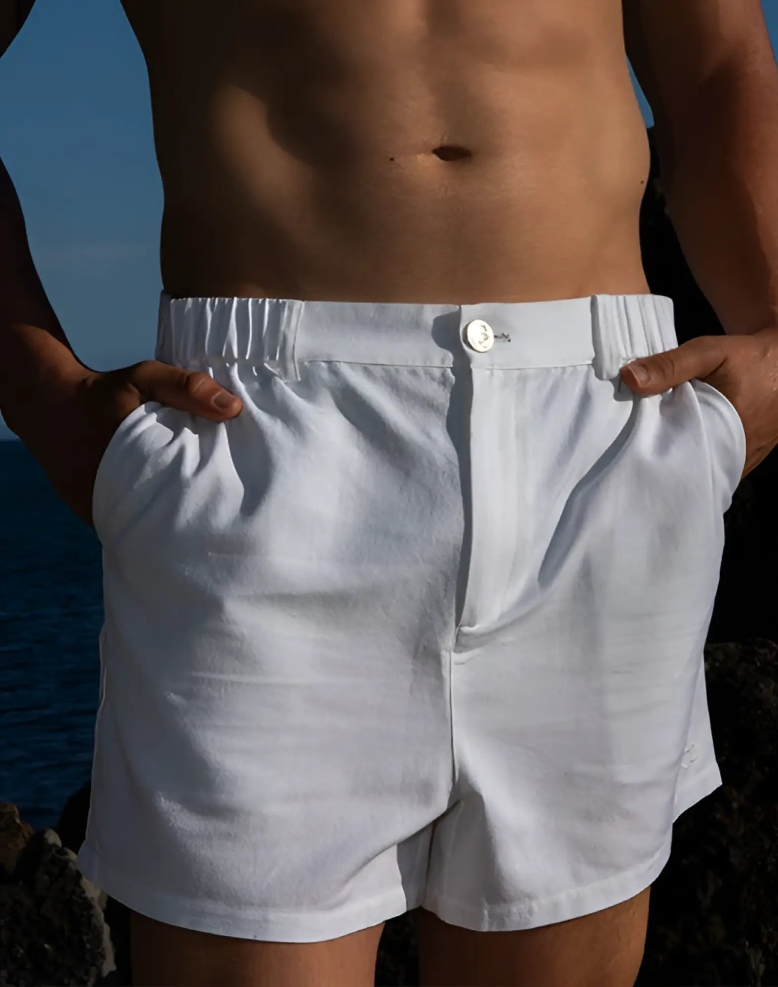 White linen 2EROS CAPRI shorts with relaxed fit elastic waistband and single button closure for casual wear
