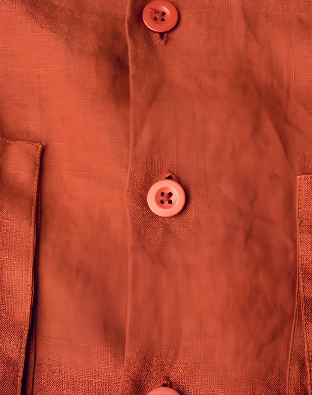 A rust-colored cropped linen shirt by 2EROS with matching buttons in Bombay Brown color