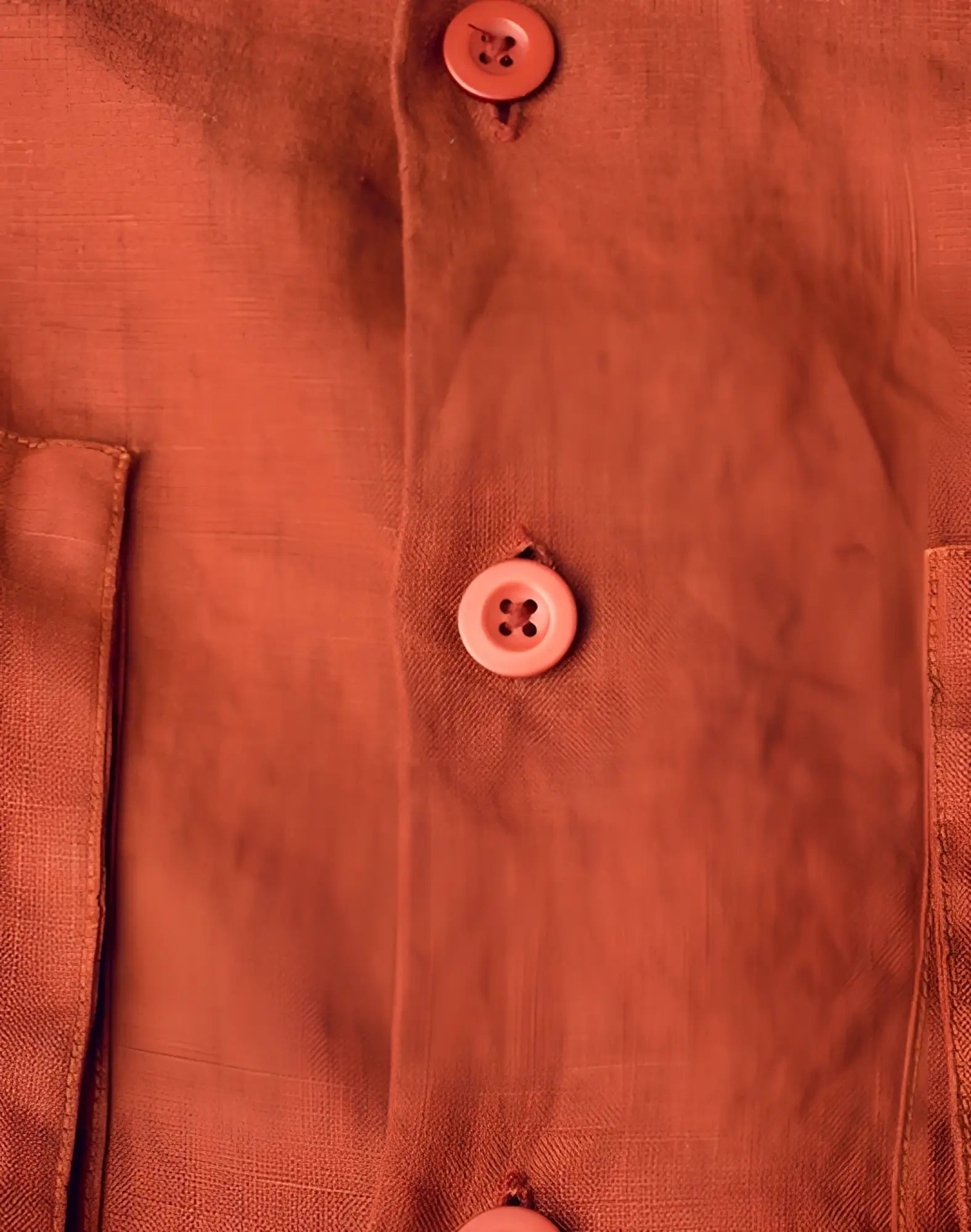 A rust-colored cropped linen shirt by 2EROS with matching buttons in Bombay Brown color