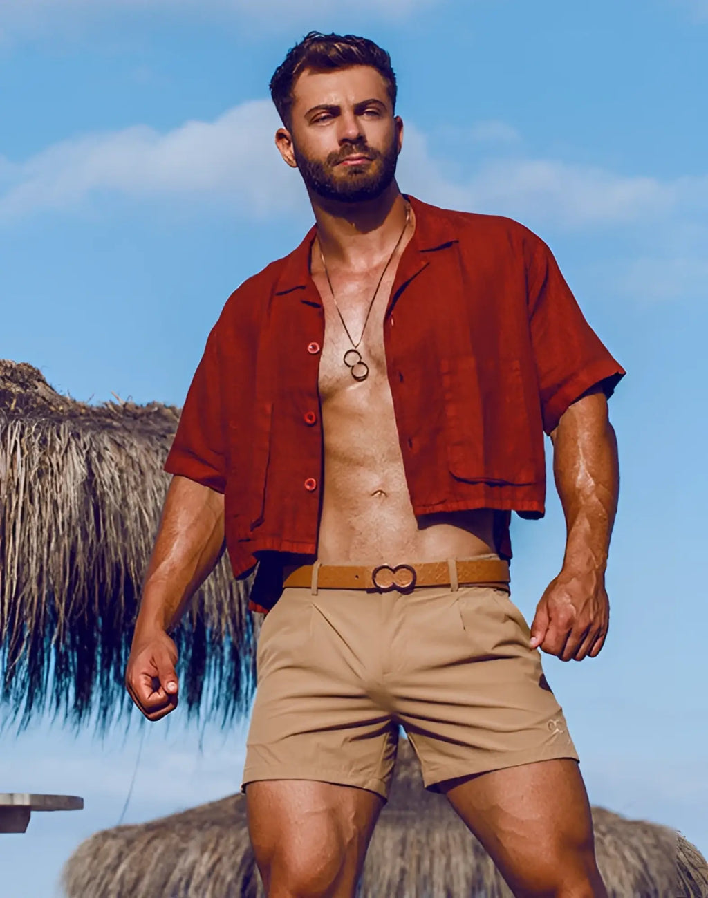 A tan leather belt with a distinctive double-looped metal buckle paired with a 2EROS cropped linen shirt in Bombay brown