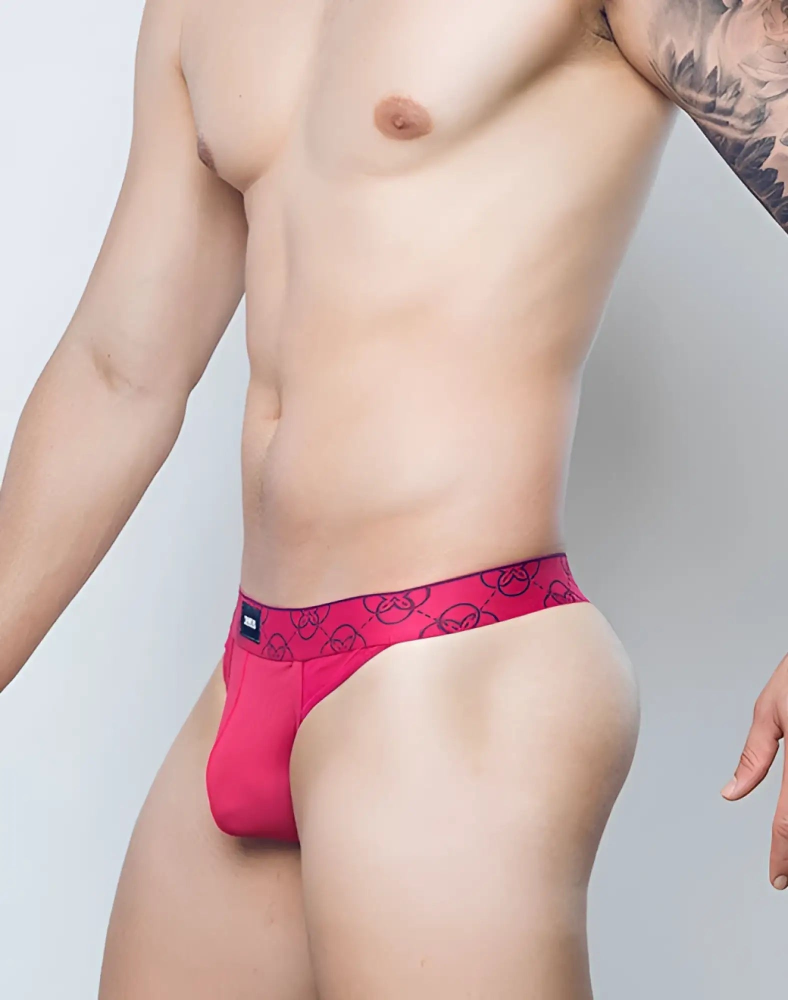 Bright pink 2eros himeros underwear thong with black circular logos and matching waistband in raspberry color