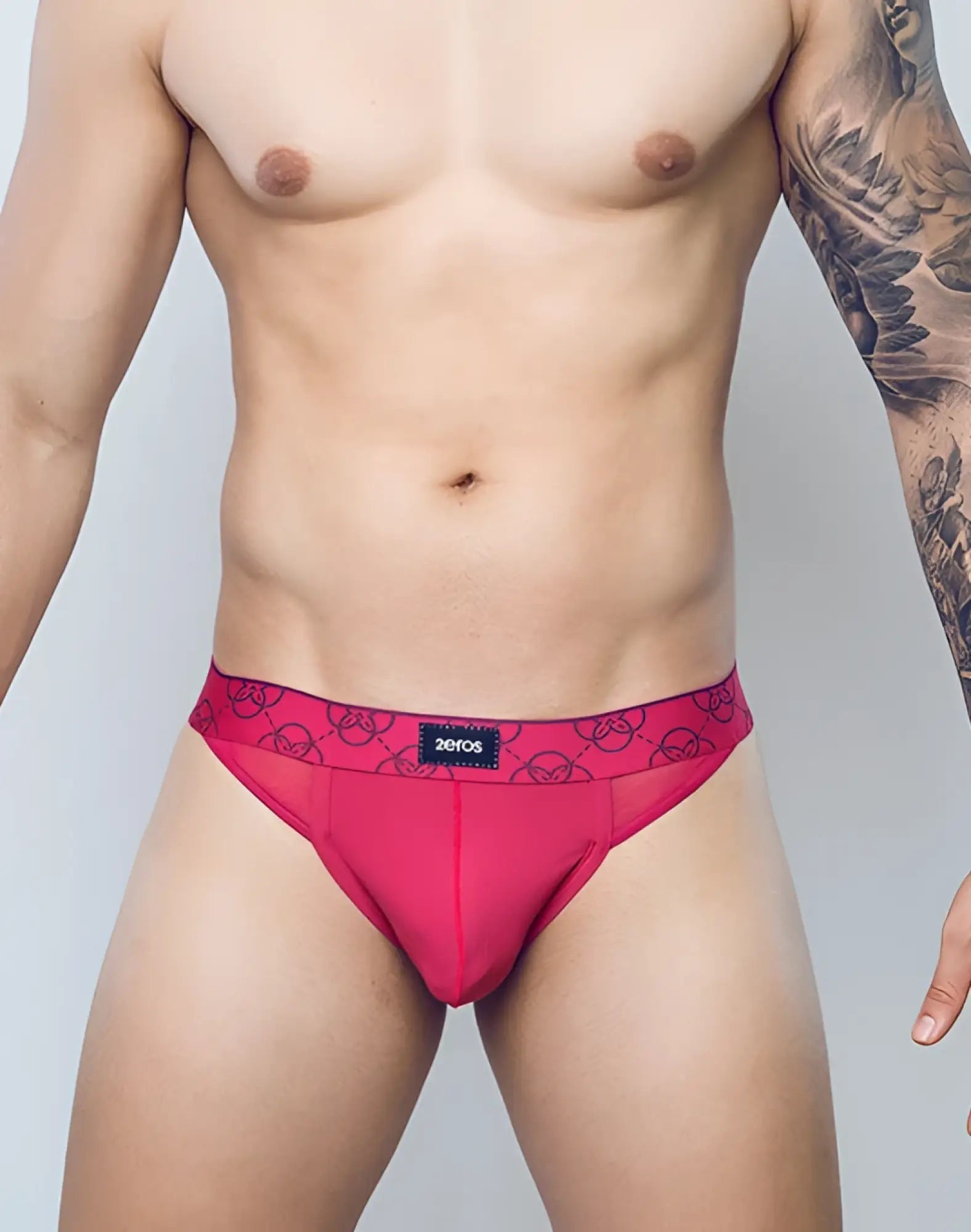 Vibrant pink 2eros himeros underwear thong with circular pattern and black zeros brand label on waistband