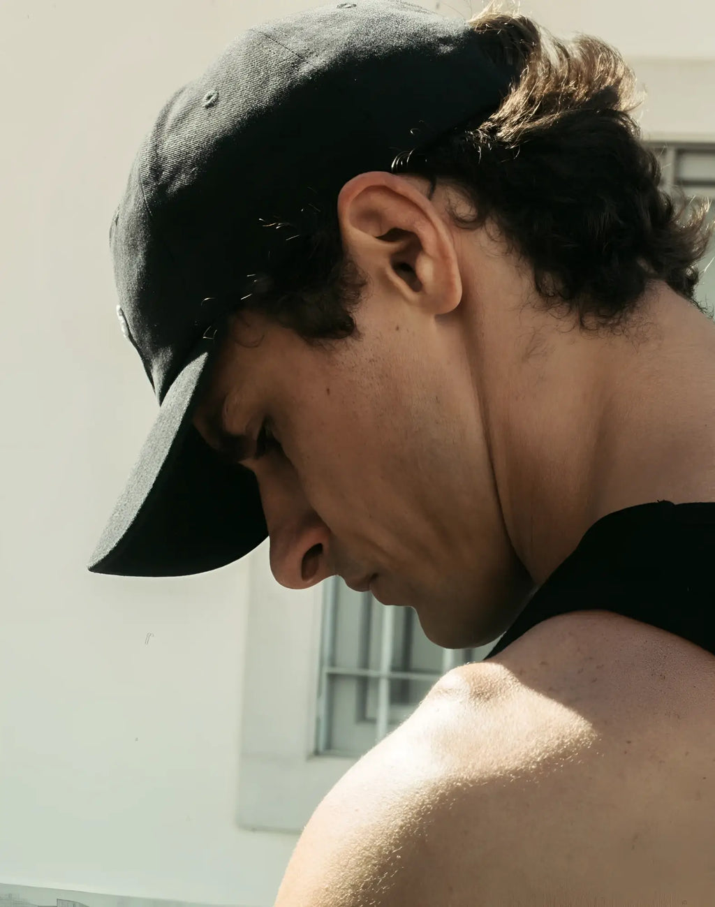 2eros icon cap black baseball cap with curved brim and adjustable strap shown from the back side