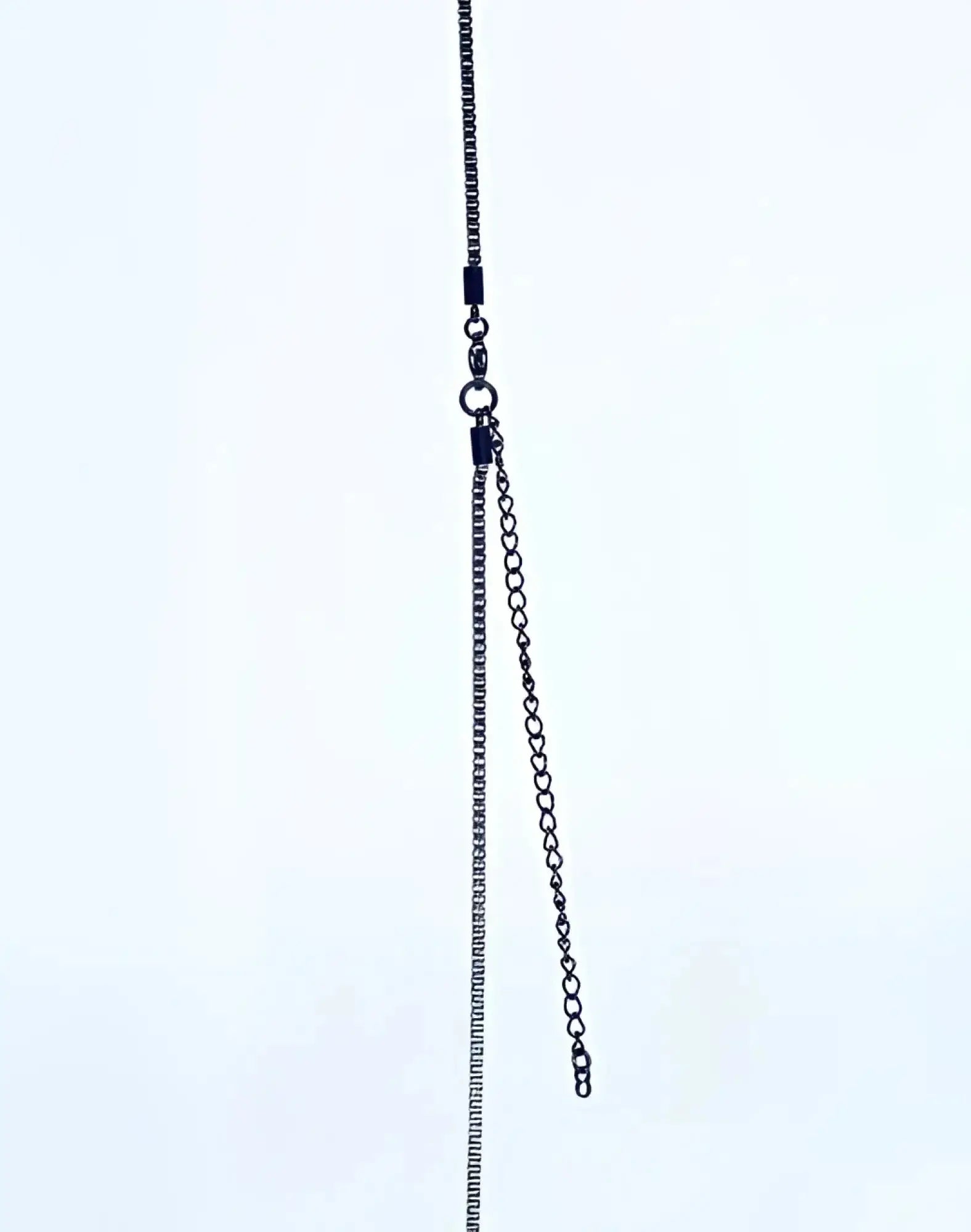2EROS icon pendant necklace in black featuring a sleek oxidized metal chain with a small extension link