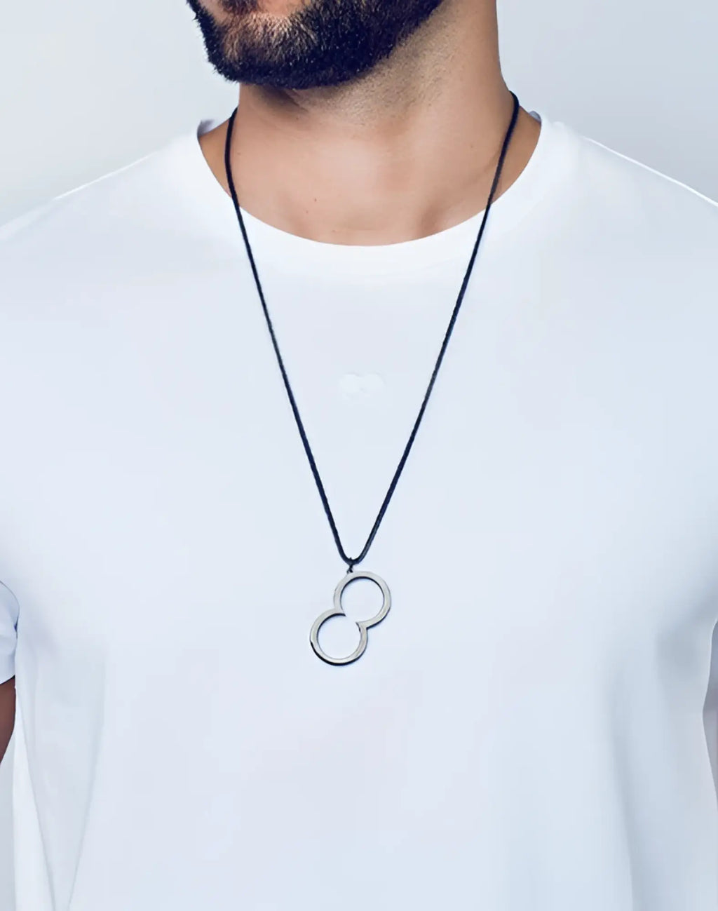 Silver infinity symbol pendant on a black cord necklace.