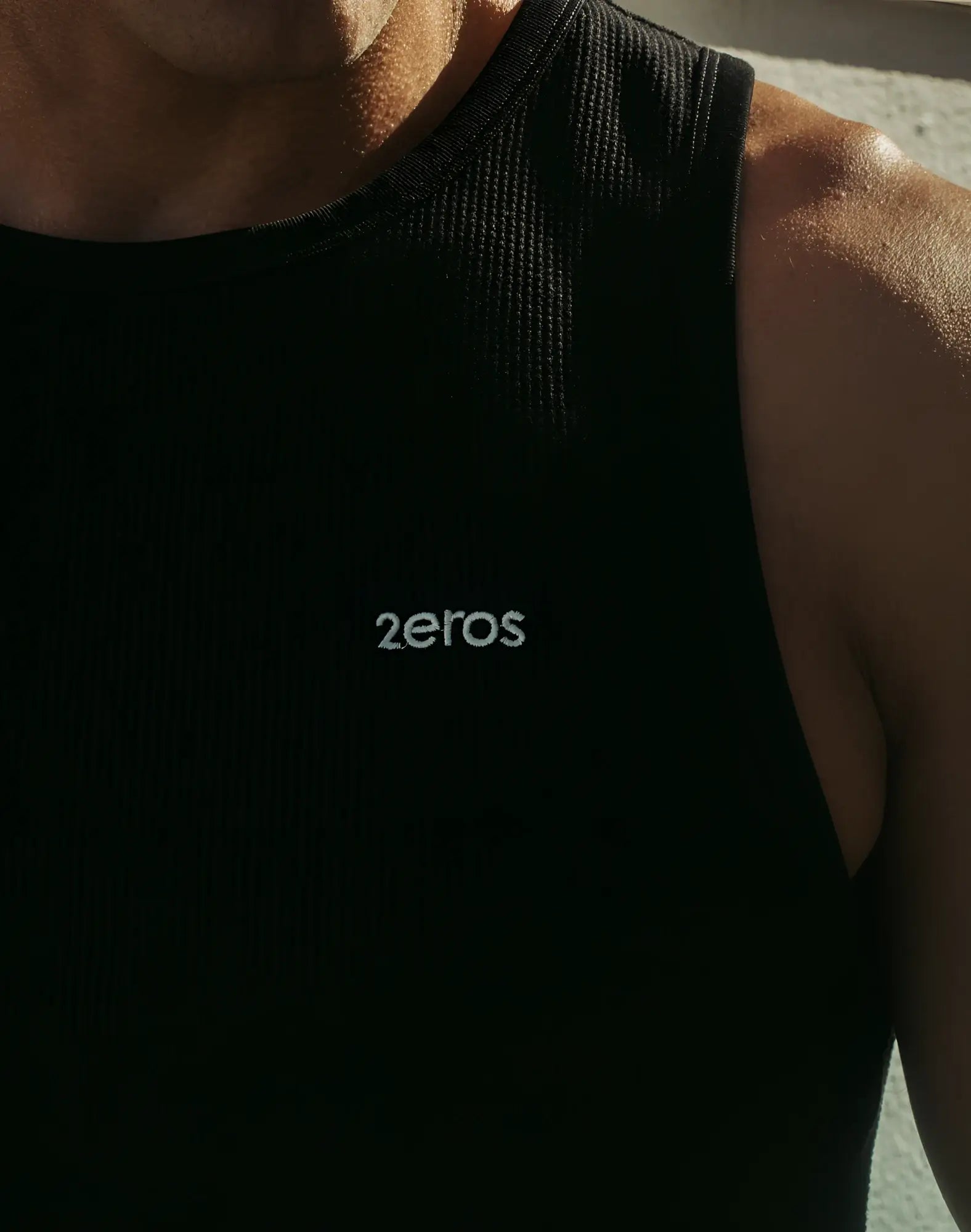 Black ribbed tank top with 2eros embroidered in white on the chest from the 2EROS Icon Singlet collection