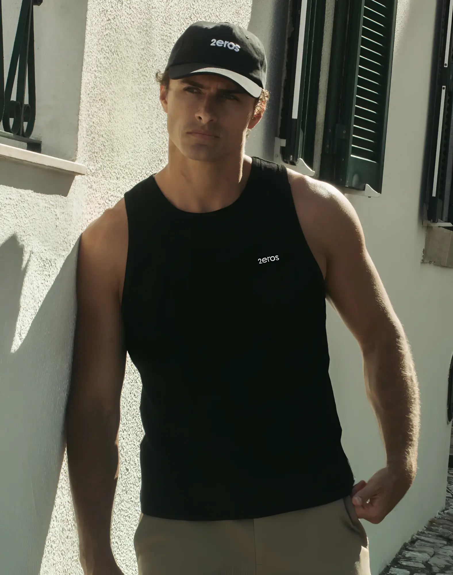 Black 2EROS icon singlet tank top with zeros logo embroidered on chest and matching black cap with white brim and branding