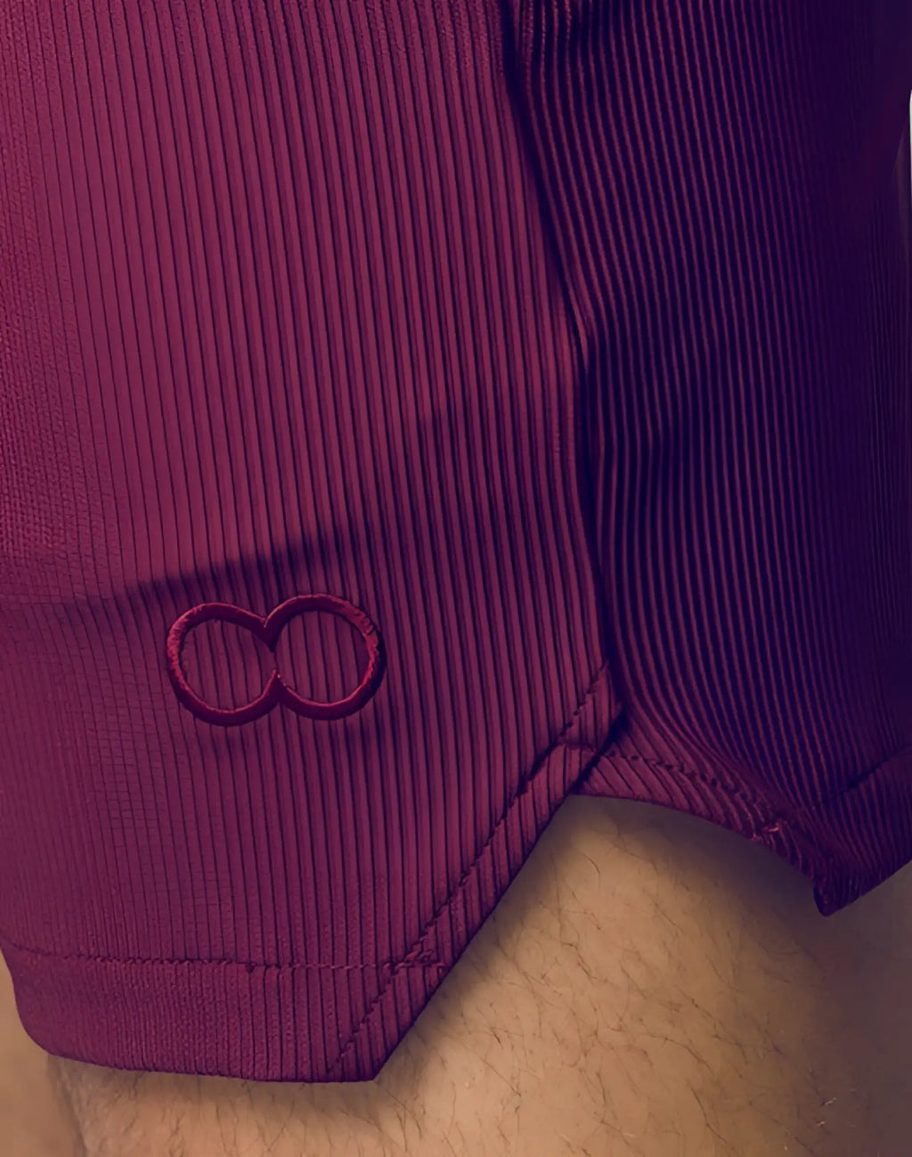 2eros manly shorts in tibetan red purple ribbed fabric with subtle embroidered infinity symbol on the side seam