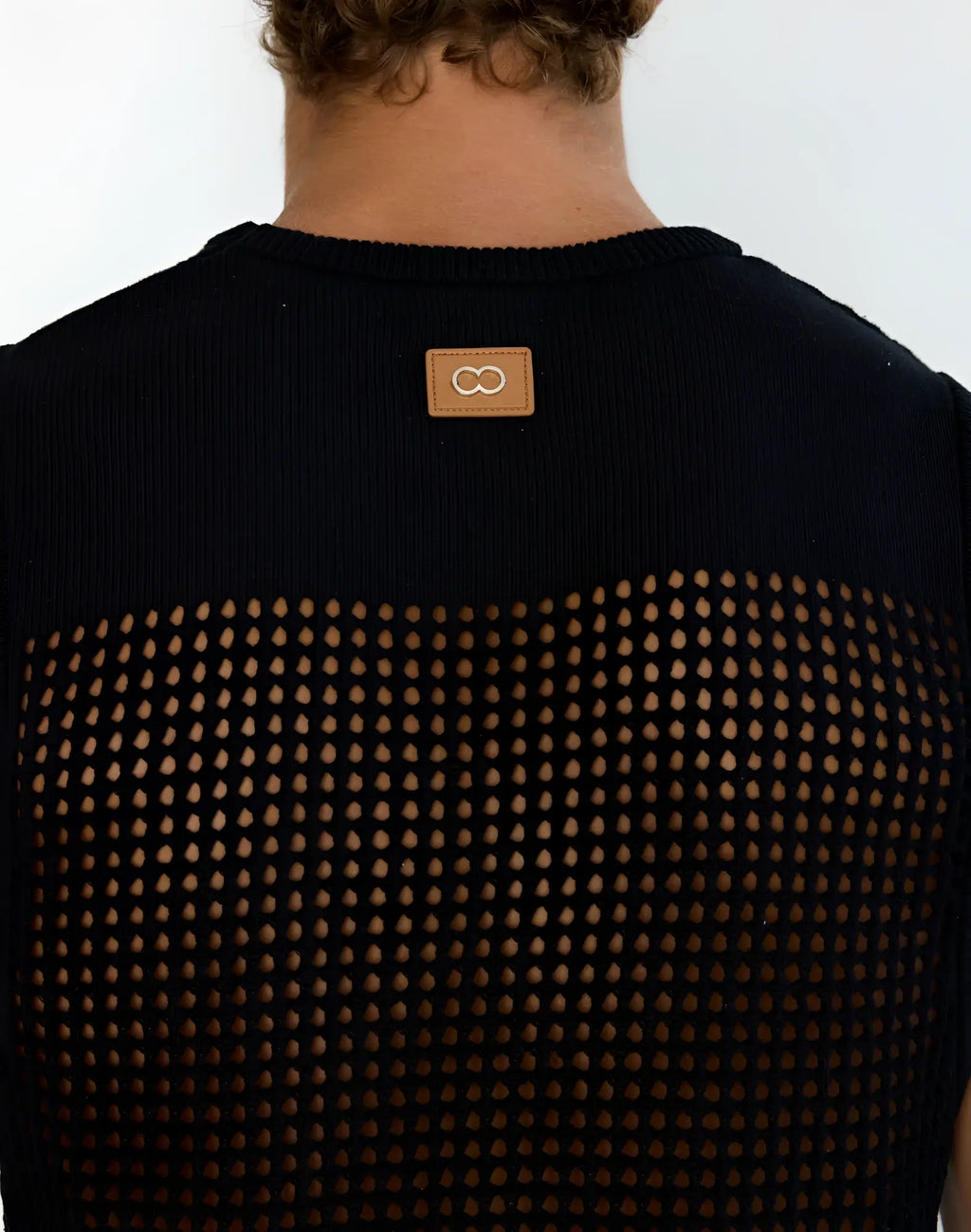 Back view of 2EROS MIAMI singlet black knitted mesh top with ribbed neckline and tan leather patch