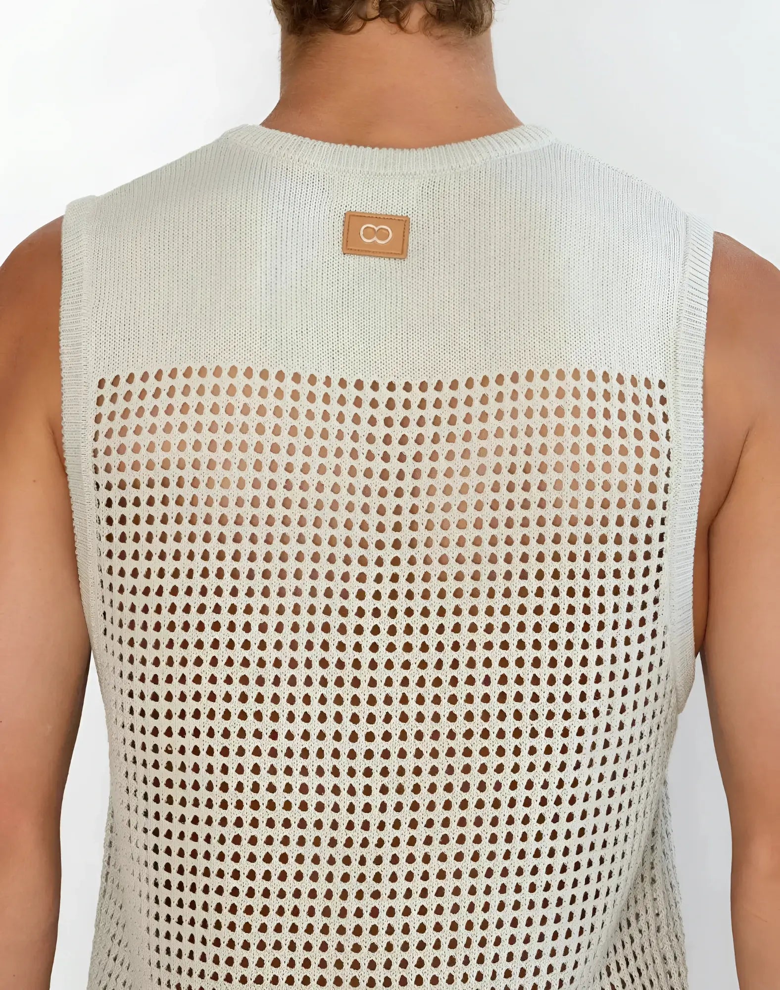 Back view of 2EROS Miami singlet grey light beige knitted sleeveless top with perforated mesh and leather patch