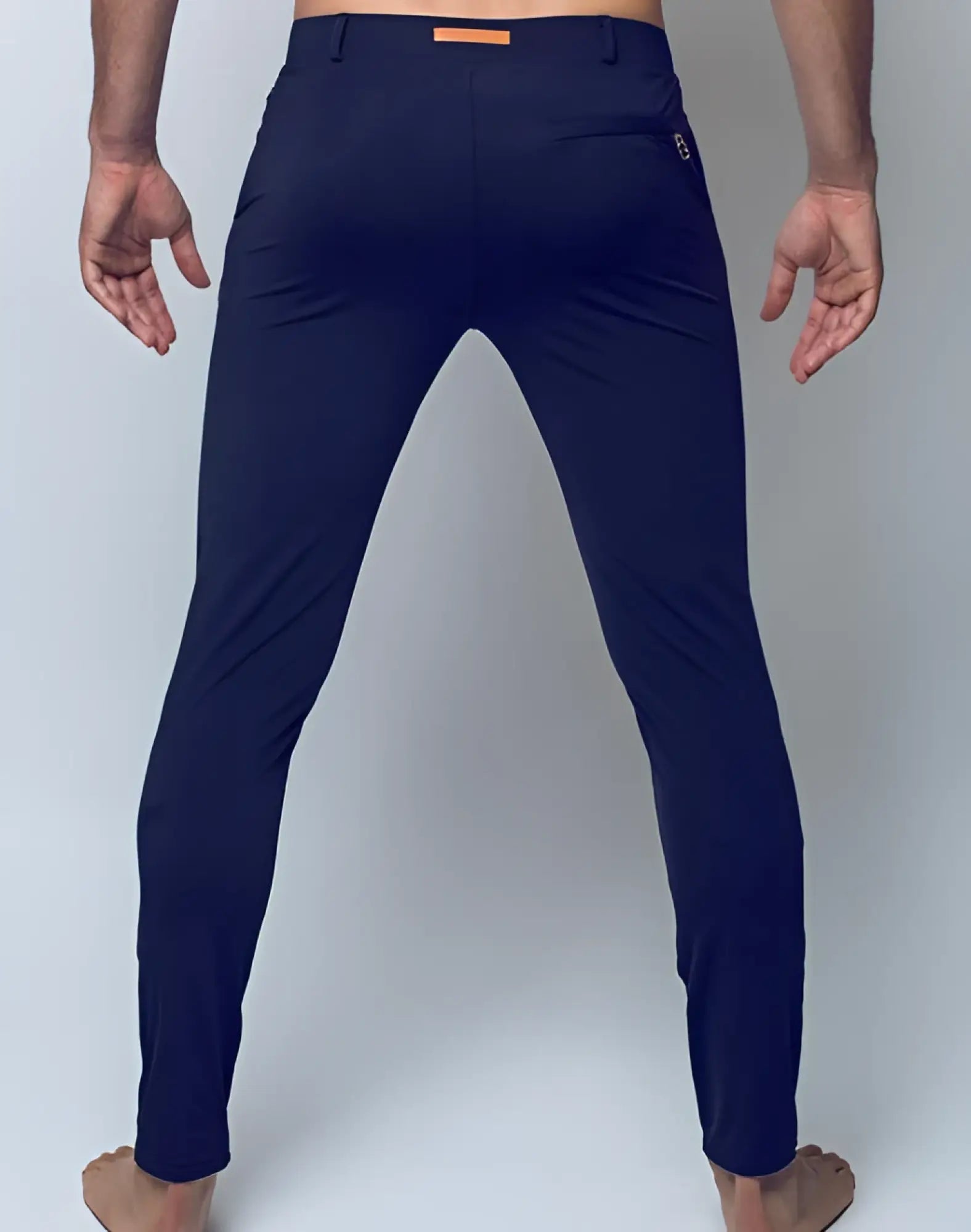 Navy blue slim-fit 2EROS P60 Bondi pants with subtle orange belt loop and logo on back pocket shown from back side