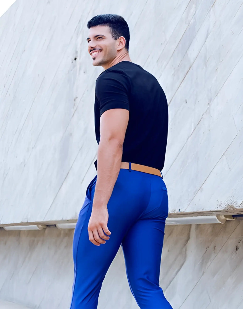 A man wearing 2EROS P60 Bondi navy pants with vibrant blue trousers and a tan belt seen from the front
