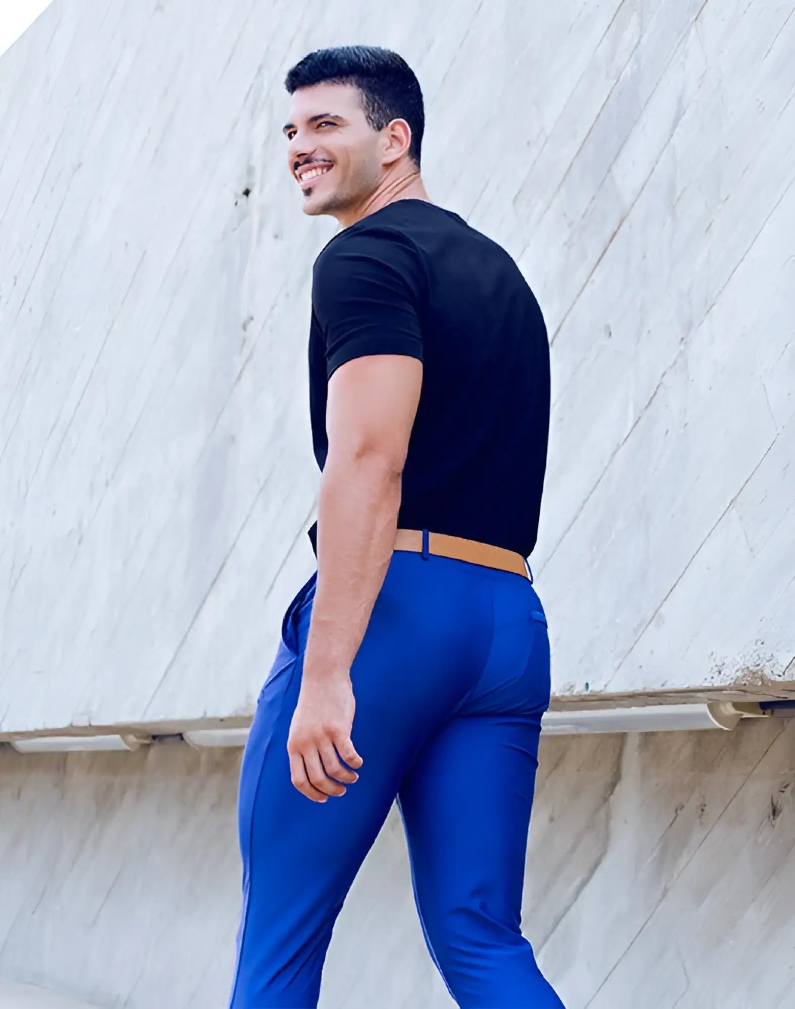 A man wearing 2EROS P60 Bondi navy pants with vibrant blue trousers and a tan belt seen from the front
