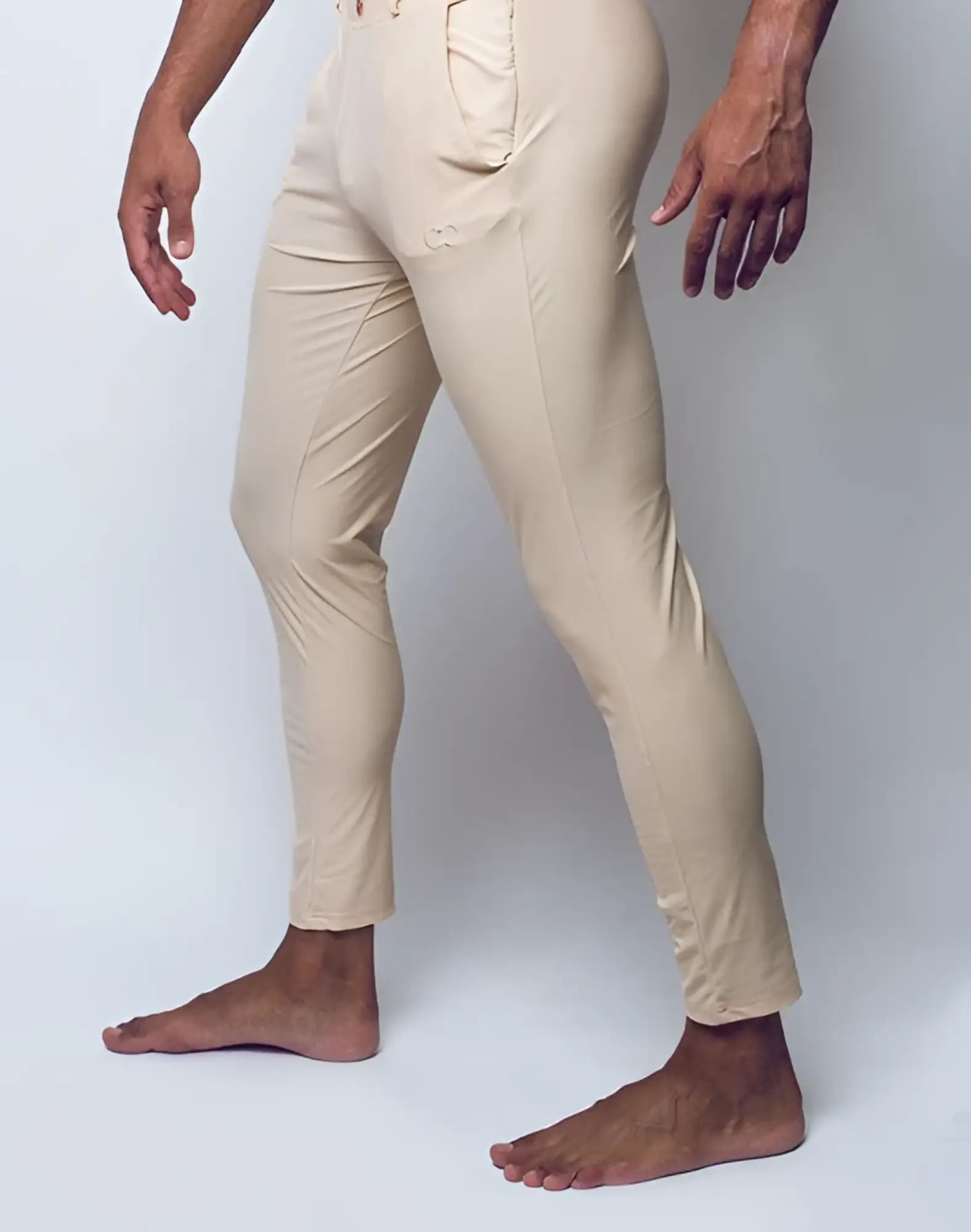 Beige slim-fit 2EROS P60 Bondi pants with subtle embroidered logo on thigh made from soft sand-colored fabric