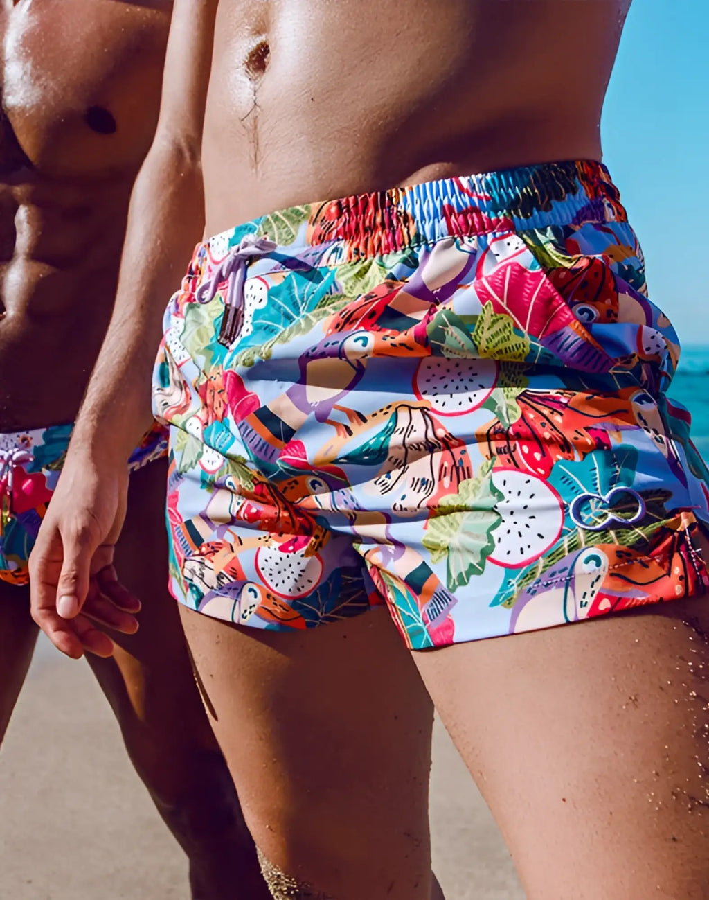 2EROS printed Bronte shorts in bright purple with vibrant tropical fruit and leaf pattern for swimwear use