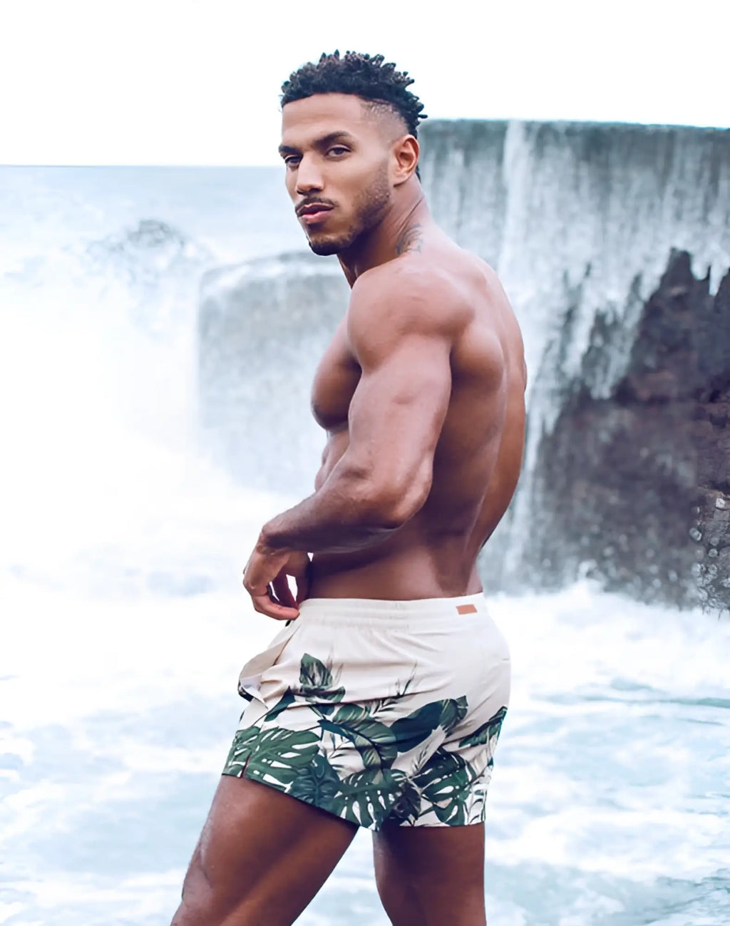 Beige 2eros printed bronte swim trunks with bold green tropical leaf pattern designed for beachwear