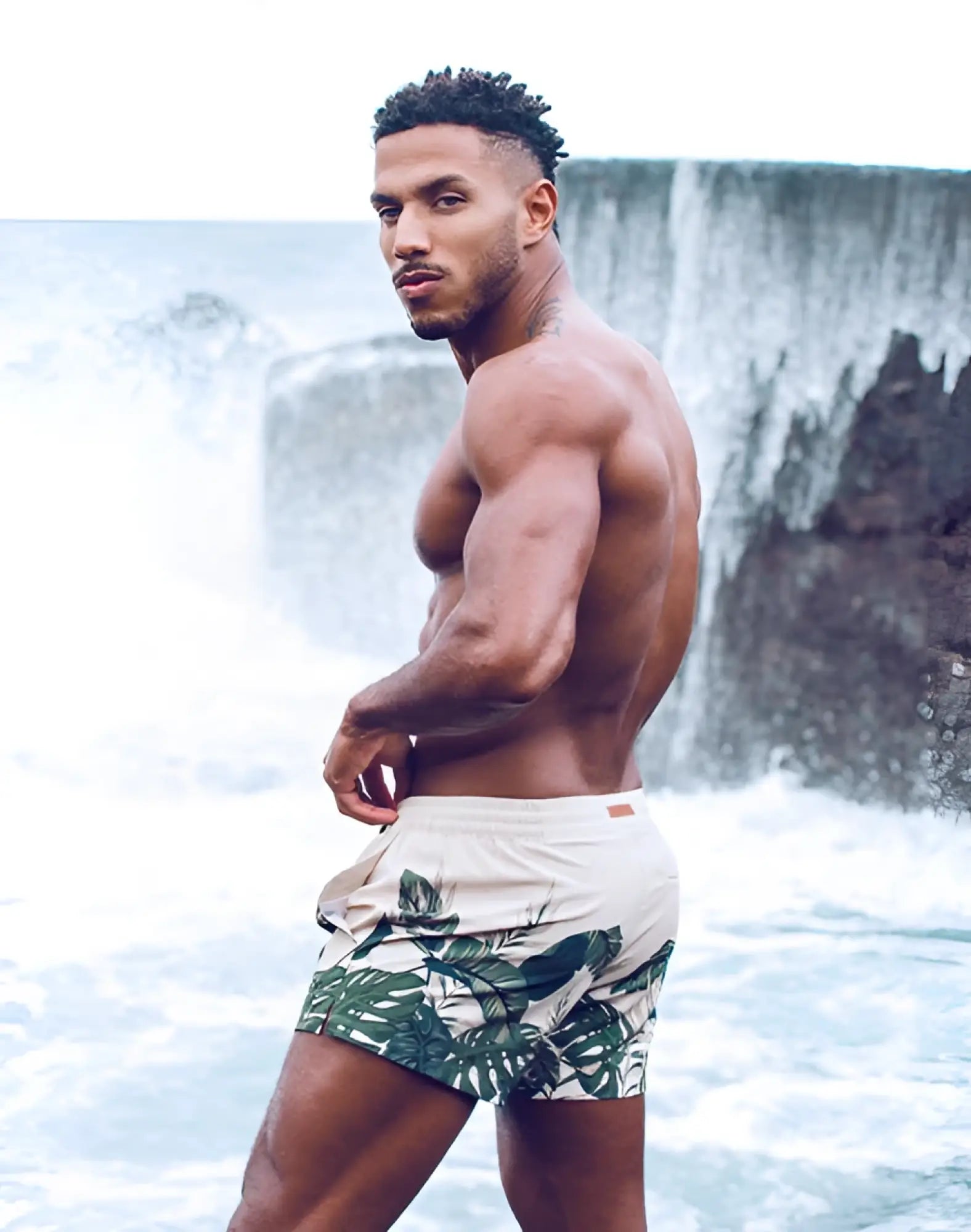 Beige 2eros printed bronte swim trunks with bold green tropical leaf pattern designed for beachwear