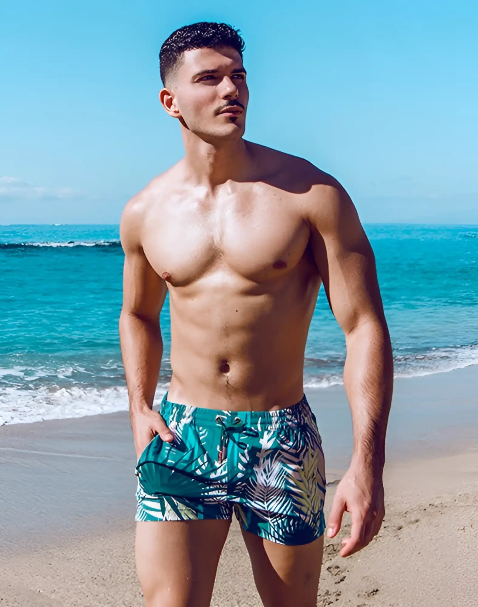 Men’s 2EROS printed Bronte shorts in teal and green tropical leaf print swim trunks with white accents