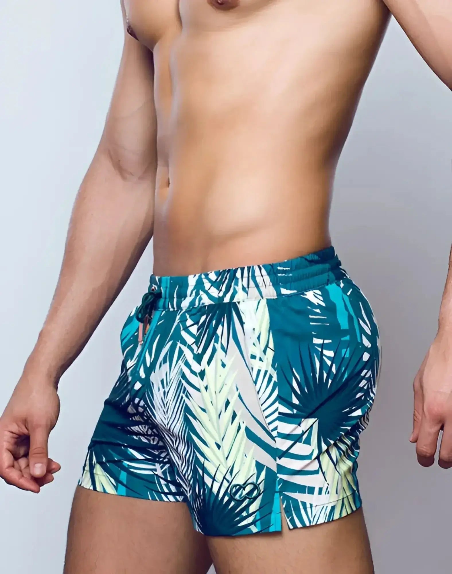 Teal and white tropical leaf pattern swim trunks with drawstring waistband from 2EROS printed bronte shorts feuille green