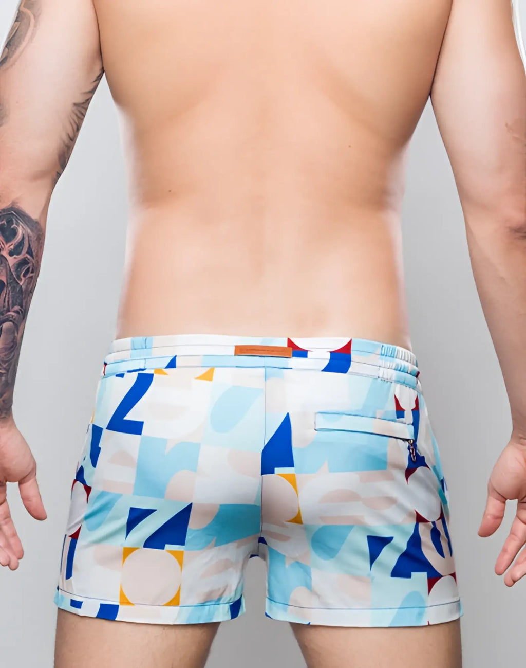2eros printed bronte shorts in insignia turquoise with blue white and yellow geometric patterns and an orange waistband tag