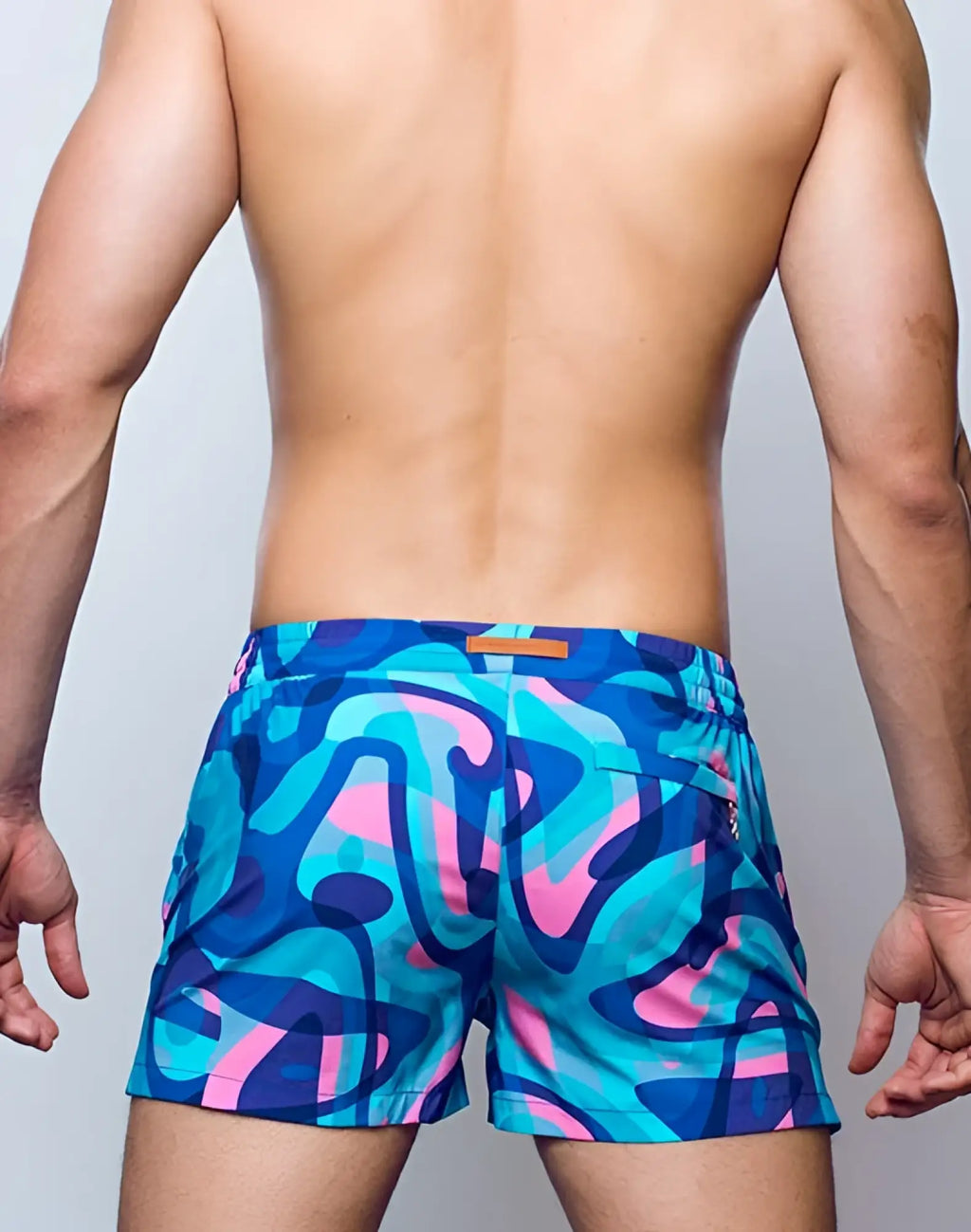 Vibrant blue and pink abstract graffiti patterned 2EROS printed Bronte swim trunks in kai blue color
