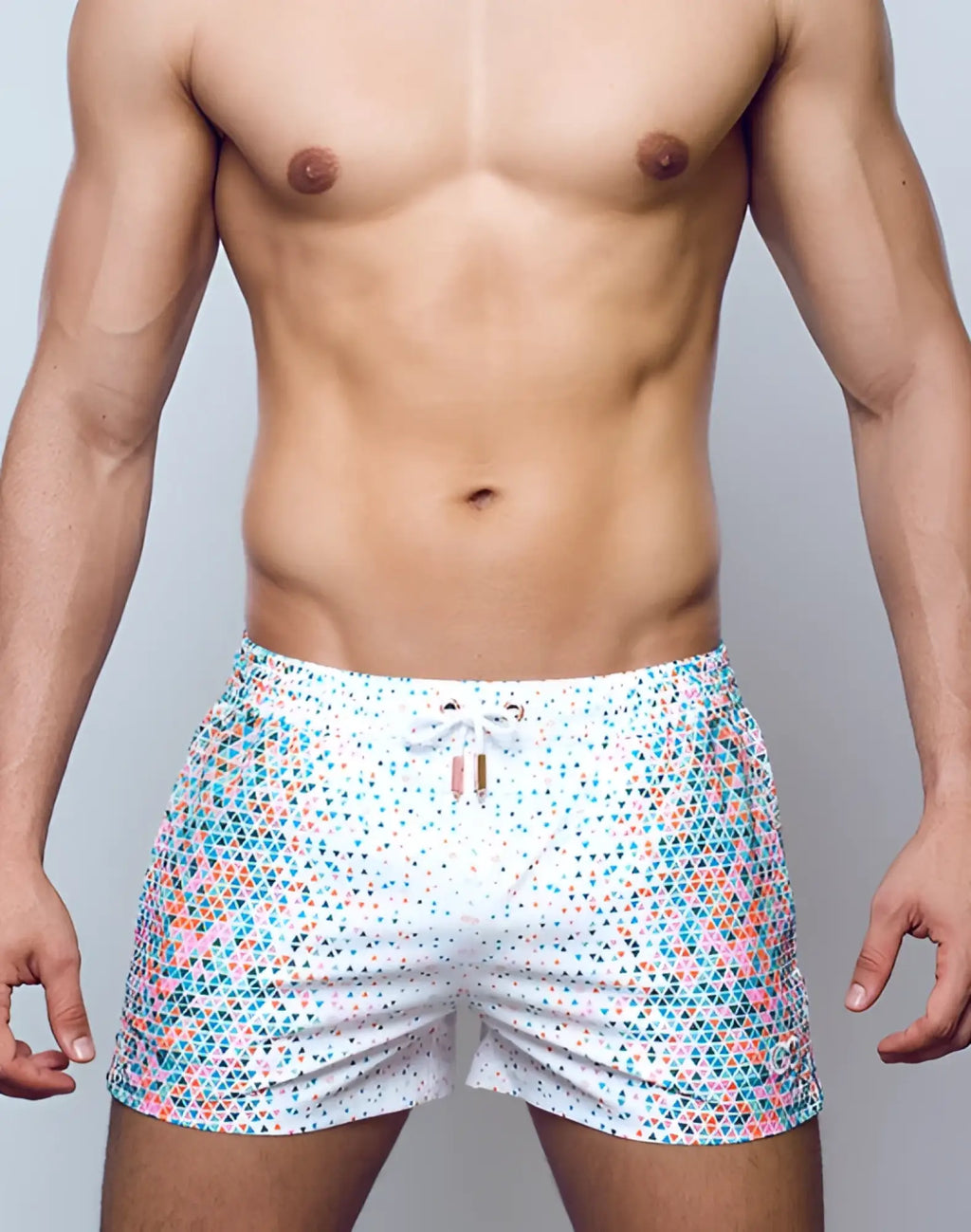 White 2EROS printed Bronte swim shorts featuring a vibrant teal pink and light blue geometric triangle pattern