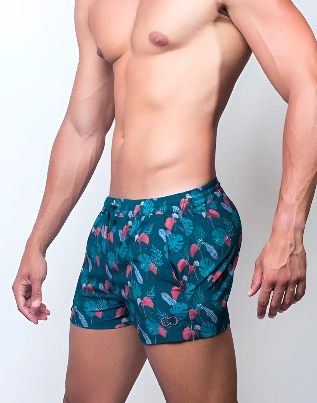 Teal 2EROS printed Bronte swim shorts with vibrant tropical monstera leaf and pink flamingo pattern for beachwear