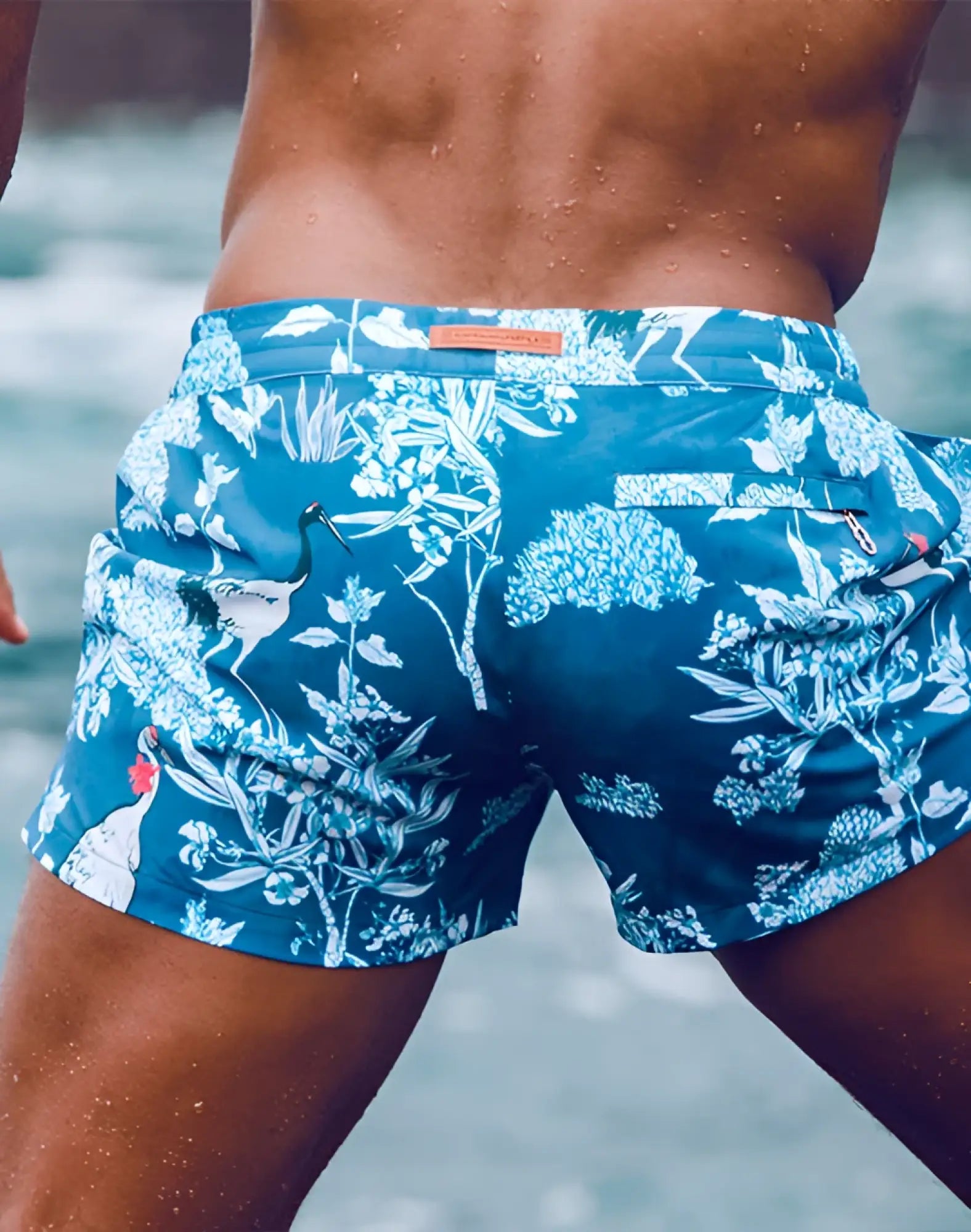 Blue swim trunks 2EROS printed bronte shorts with white botanical and crane pattern ideal for beachwear