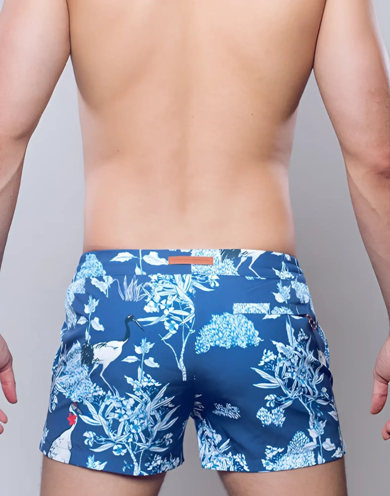 Blue swim trunks with white and light blue botanical print and crane motifs from 2EROS printed Bronte shorts orient dream collection