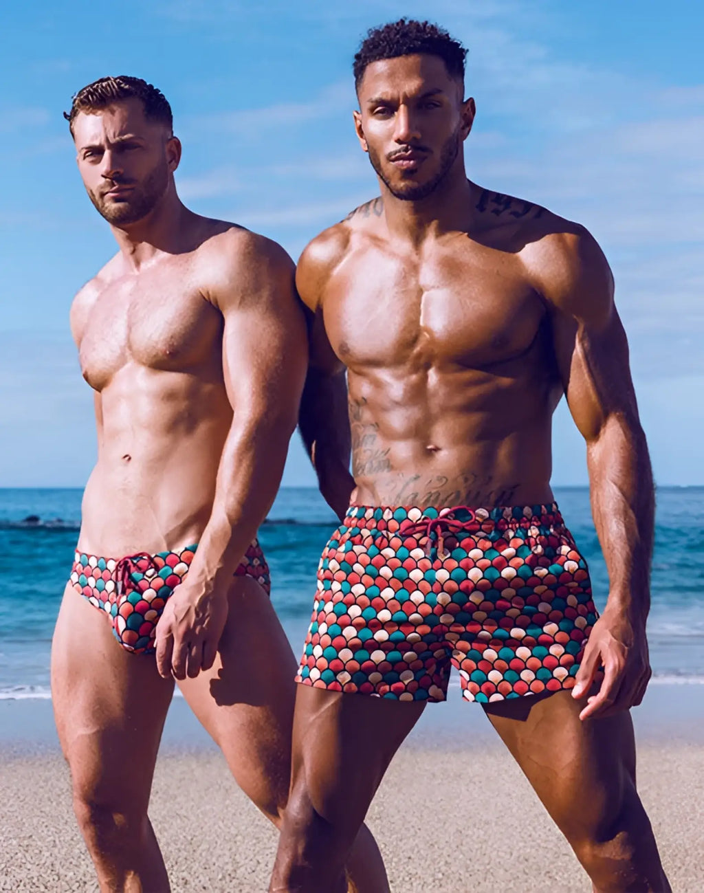 Men wearing 2EROS printed bronte shorts in retro red with colorful circular swim trunks pattern