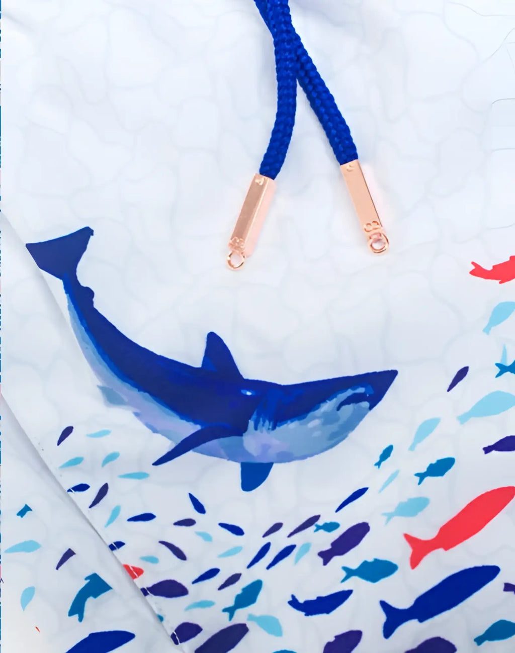 White 2EROS printed Bronte swim trunks featuring bold blue shark and colorful fish print with navy drawstrings and rose gold hardware