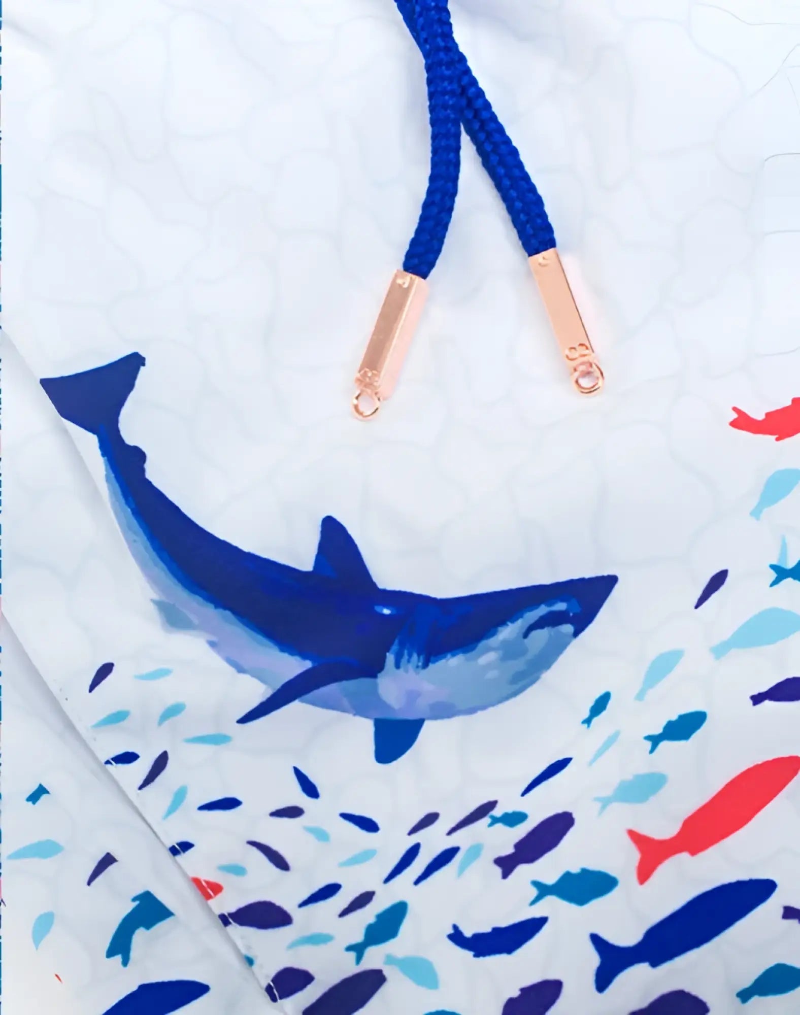 White 2EROS printed Bronte swim trunks featuring bold blue shark and colorful fish print with navy drawstrings and rose gold hardware