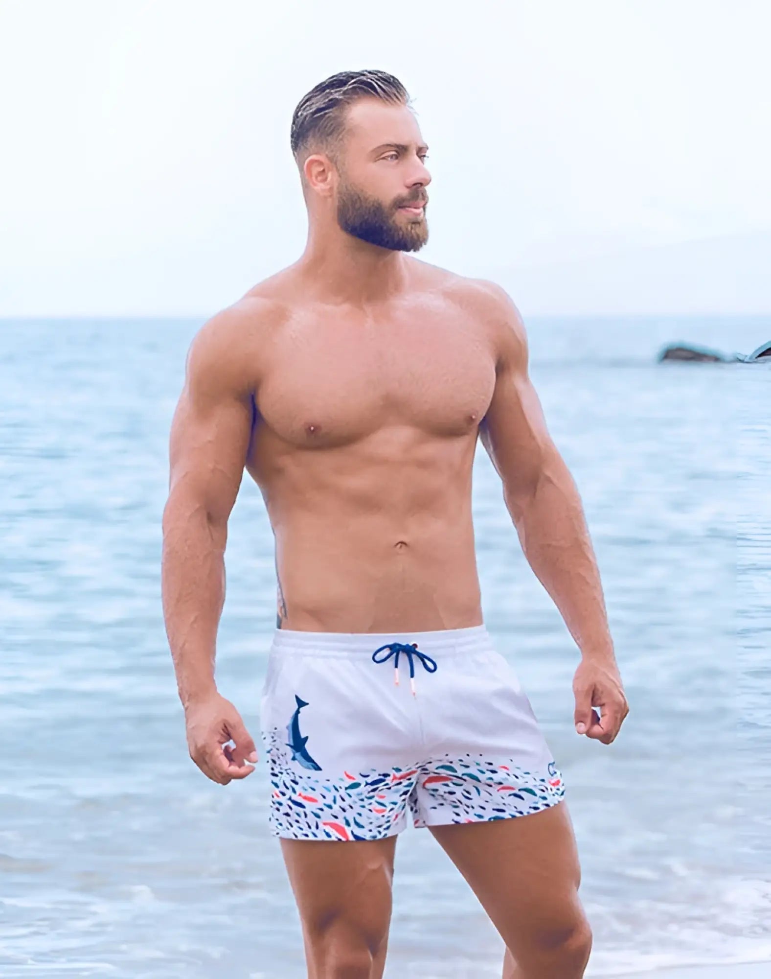 White swim trunks 2EROS printed bronte shorts with colorful fish dolphin pattern and blue drawstrings seascape white
