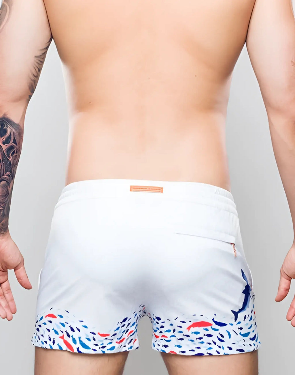 2eros printed bronte white swim trunks with vibrant blue red and black fish pattern along the hem