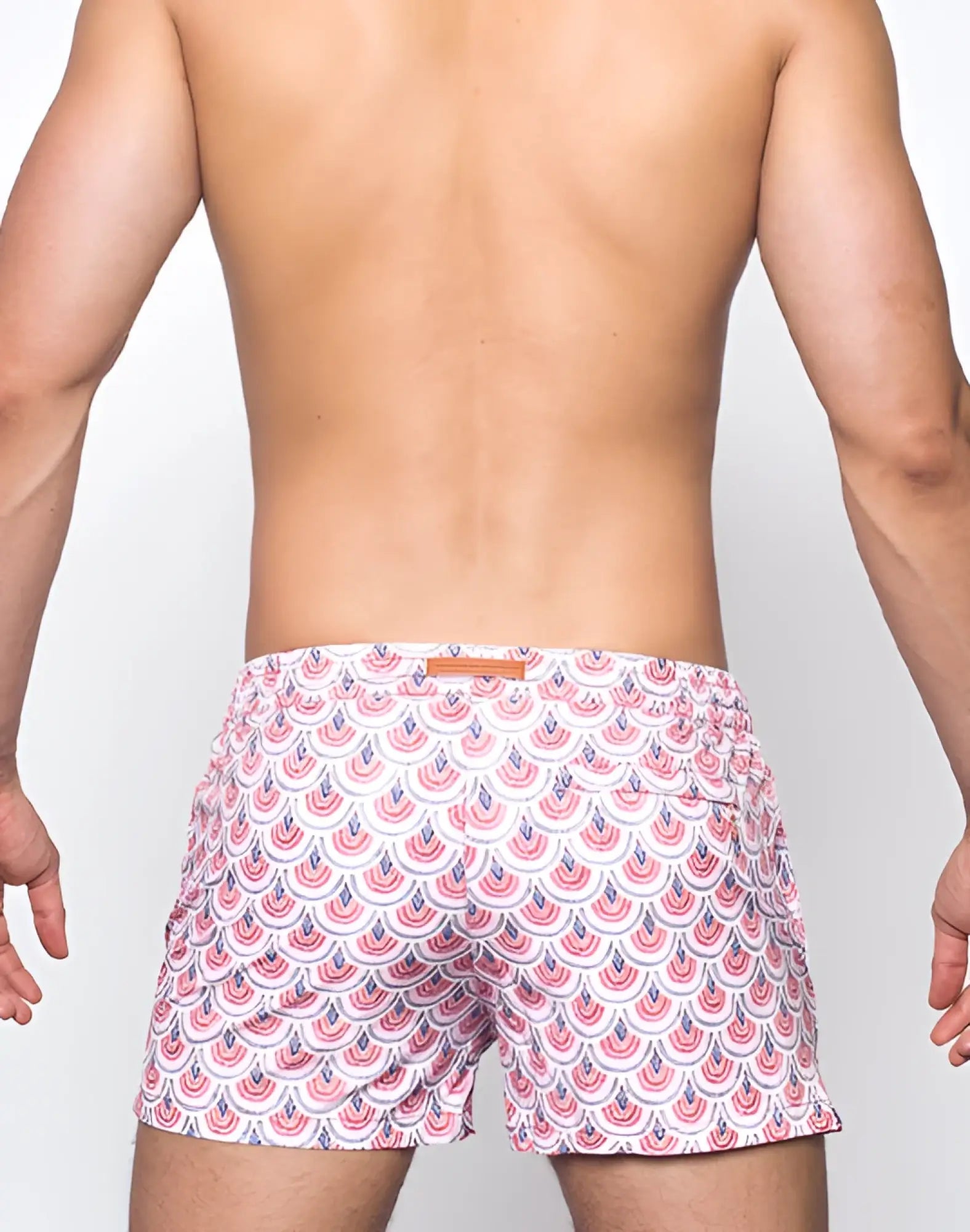 White 2EROS printed Bronte shorts featuring a repeating pink and navy blue scalloped pattern swim trunks