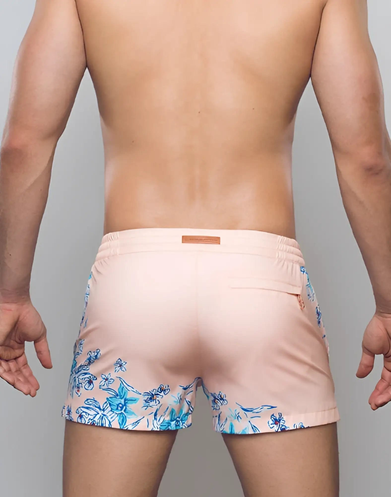 Pastel pink 2EROS printed Bronte swim trunks with blue floral pattern on sides and hem in Tahiti Peach color