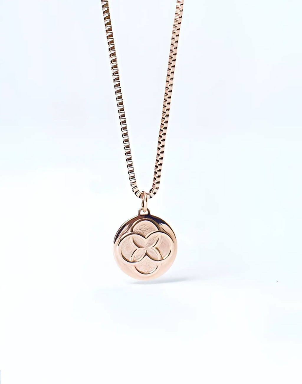 Rose gold 2EROS Regalia pendant necklace with a circular three-leaf clover design on the front