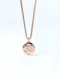 Rose gold 2EROS Regalia pendant necklace with a circular three-leaf clover design on the front
