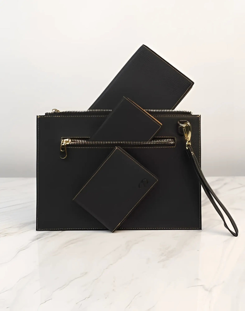Black leather 2EROS RFID Icon Carry All clutch with gold-tone zipper and wrist strap for secure and stylish carrying