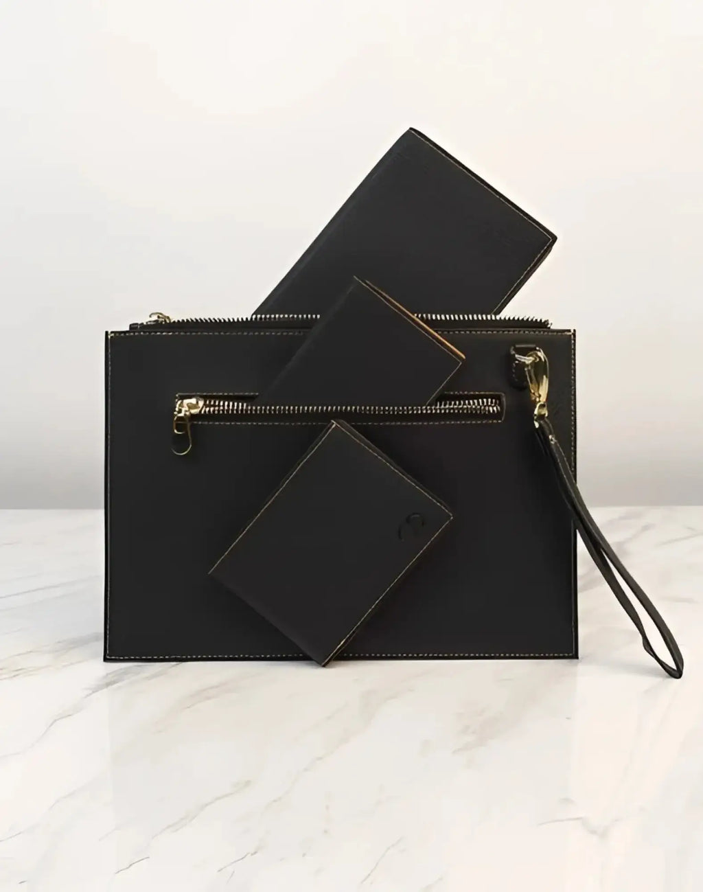 Black leather 2EROS RFID Icon Carry All clutch with gold-tone zipper and wrist strap for secure and stylish carrying