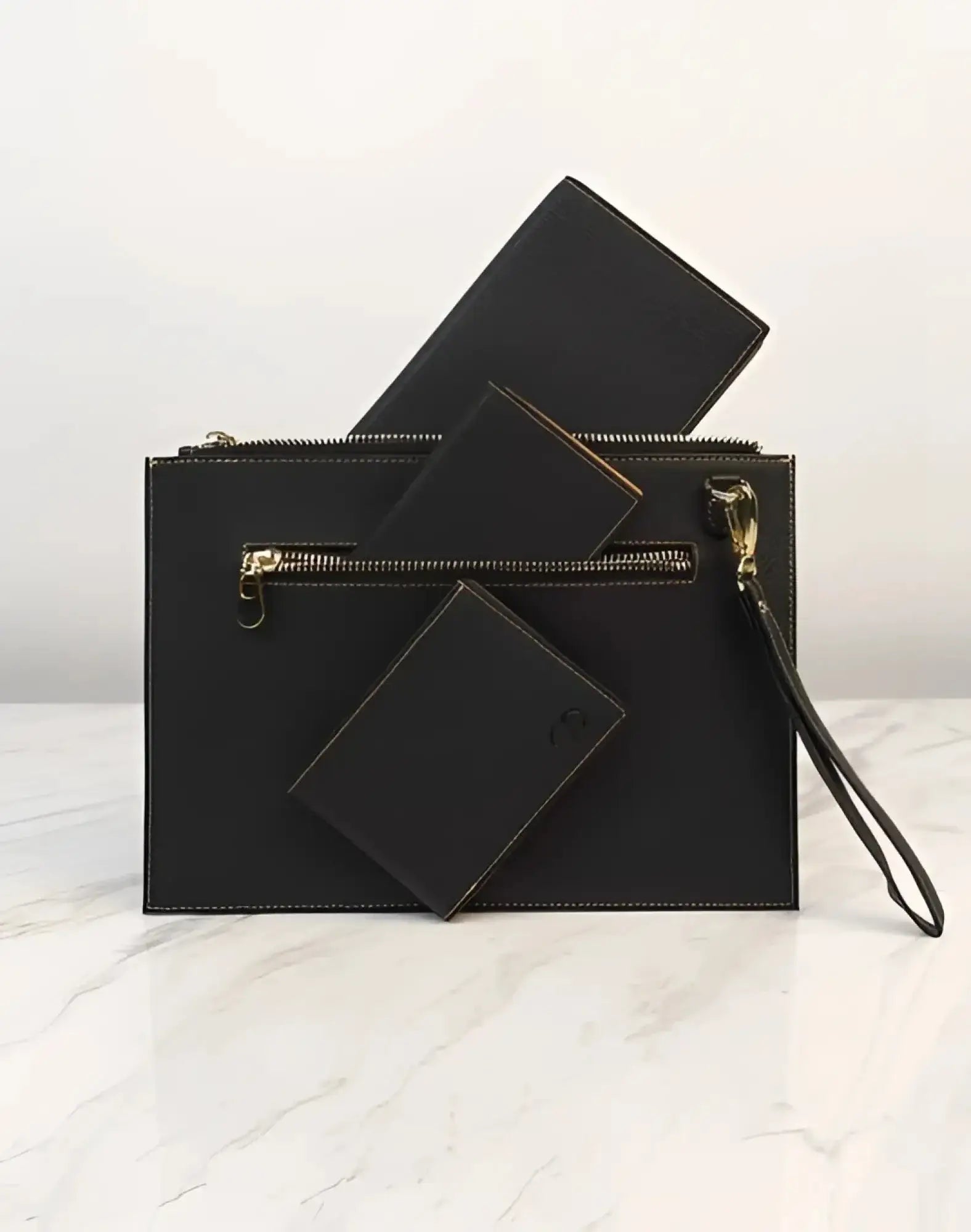 Black leather 2EROS RFID Icon Carry All clutch with gold-tone zipper and wrist strap for secure and stylish carrying
