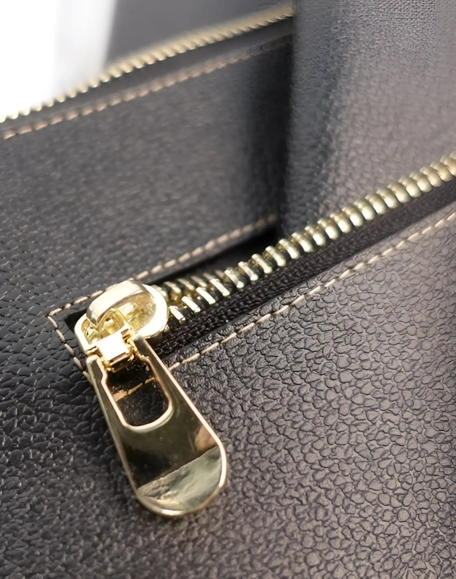 Black textured leather 2eros rfid icon carry all with gold-toned zipper pull for secure storage and style
